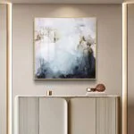 Modern abstract wall art with gold frame in a luxury home setting.