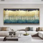 Modern luxury living room with large framed wall art featuring abstract design in gold and blue tones.