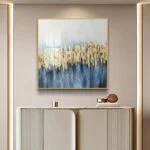 Modern luxury wall art with gold and blue abstract design in a stylish living room.