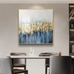 Modern luxury wall art with gold and blue abstract design in a dining room setting.