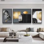 Modern luxury wall art set with abstract designs in a contemporary living room.