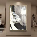 Modern abstract wall art with gold accents in a luxury living room setting.
