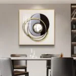 Modern luxury wall art with circular design and gold accents in a dining room setting.