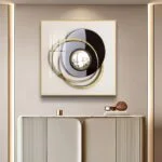 Modern luxury wall art with circular design and gold accents above a sleek console table.