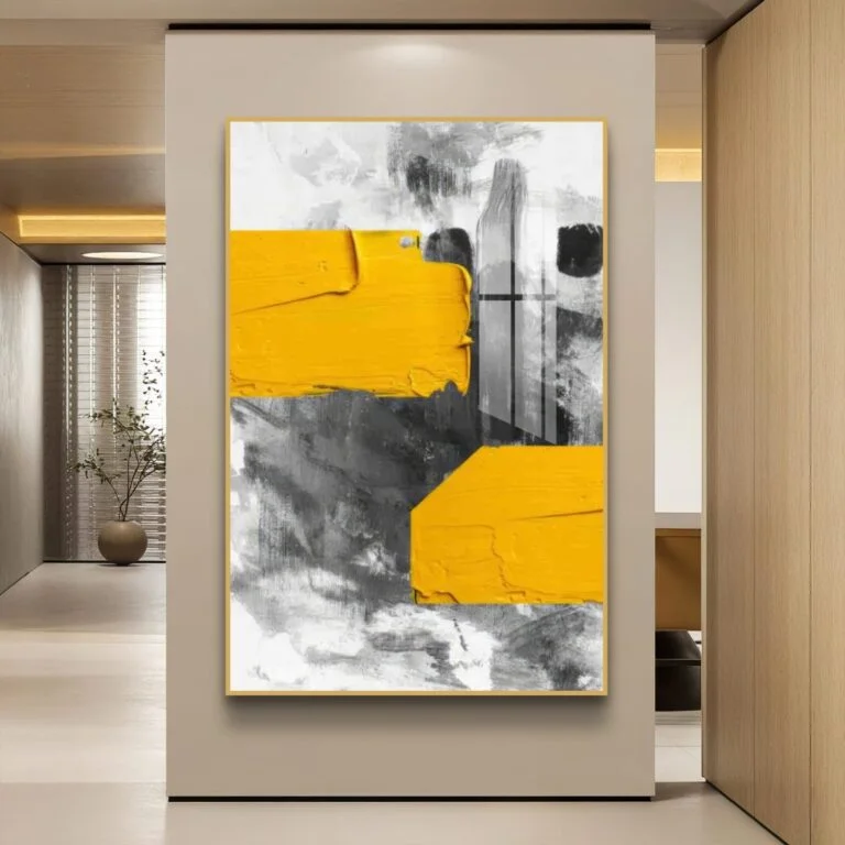 Modern abstract wall art with yellow and gray tones in a luxury home setting.