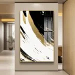 Modern abstract wall art with black, white, and gold swirls in a sleek hallway.