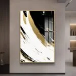 Modern abstract wall art with gold and black swirls in a sleek frame, enhancing luxury home decor.