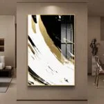 Modern abstract wall art with black, white, and gold swirls in a luxury living room setting.