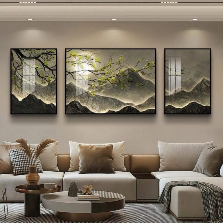 Modern living room with three-panel framed wall art depicting a serene mountain landscape.