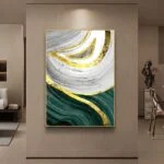 Modern abstract wall art with gold, green, and white swirls in a luxury living room setting.