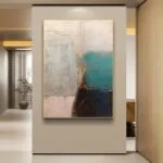 Modern abstract wall art with gold frame in a luxury home setting.