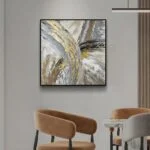 Modern abstract wall art with gold accents in a luxury home setting.