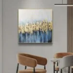 Modern luxury wall art with gold and blue abstract design in a living room setting.