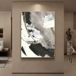 Modern abstract wall art with gold accents in a luxury living room setting.