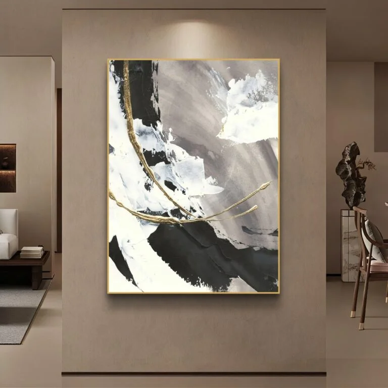 Modern abstract wall art with gold accents in a luxury living room setting.