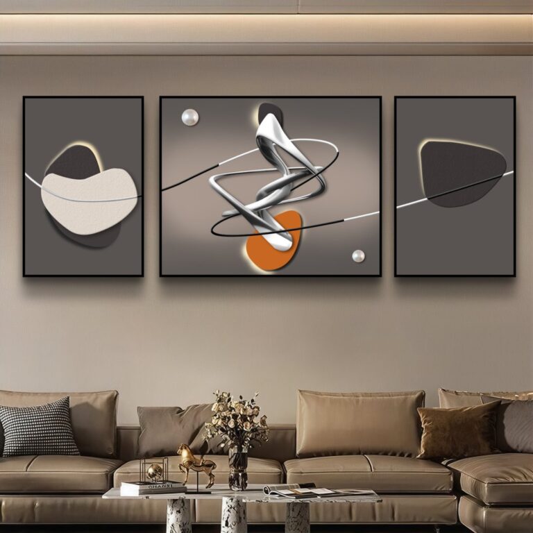 Modern abstract wall art in black frames above a beige sofa in a luxury living room.