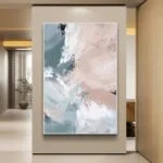 Modern abstract wall art in soft pastel colors, framed and displayed in a luxury home setting.