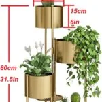 Gold metal indoor planters with plants, modern home decor.