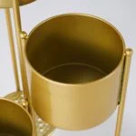 Gold metal planter with modern design for luxury home decor.
