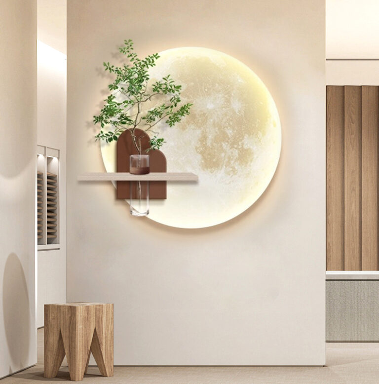 Modern illuminated wall art with a moon design and decorative vase on a shelf.