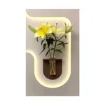 Illuminated wall art with yellow flowers in a vase, modern home decor.