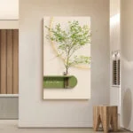 Modern wall art with a green plant in a vase on a textured background.