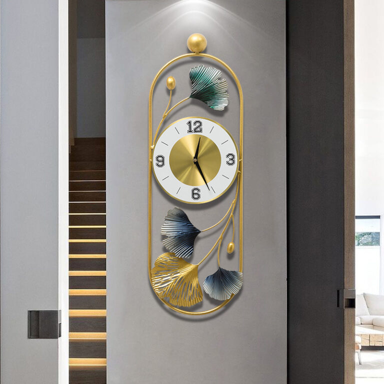 Modern luxury wall clock with gold frame and leaf design, perfect for home decor.