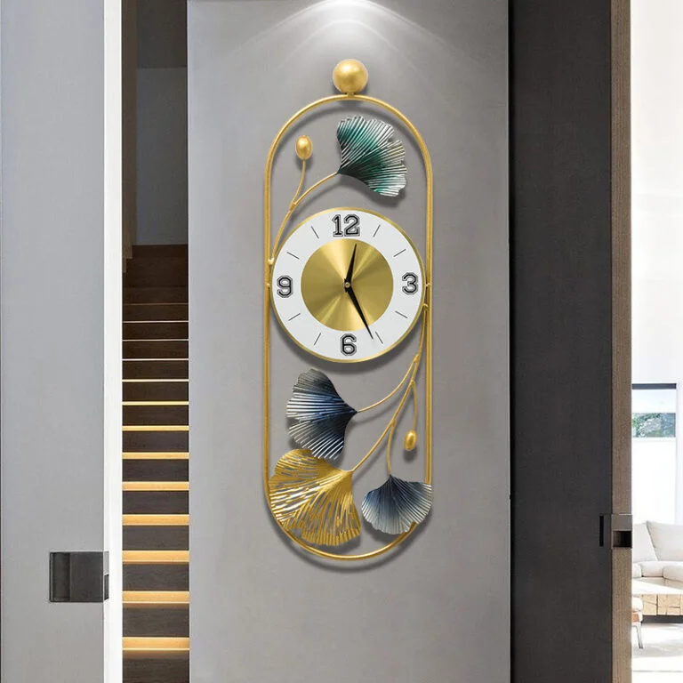 Modern luxury wall clock with gold frame and leaf design, perfect for home decor.