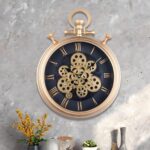 Luxury gold wall clock with Roman numerals and gear design on a textured wall.