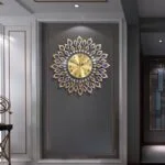 Luxury decorative wall clock with gold and blue accents in a modern interior setting.
