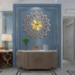 Luxury gold and blue decorative wall clock in modern living room setting.
