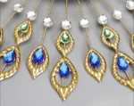 Luxury gold and crystal decorative wall art with blue and green accents.