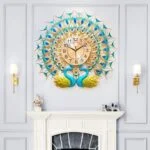Peacock-themed decorative wall clock with gold and blue accents above a white fireplace.