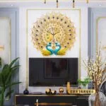 Luxury peacock wall clock with gold and blue accents in a modern living room setting.