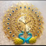 Luxury decorative wall clock with gold peacock feather design and blue accents.