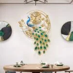 Luxury peacock wall clock with gold and blue accents in a modern dining room.