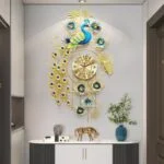 Luxury peacock wall clock with gold accents and floral design in modern home decor setting.
