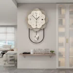 Modern luxury wall clock with decorative shelf in a stylish living room.