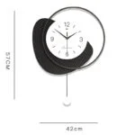 Modern decorative wall clock with black and white design, featuring a circular frame and minimalist style.