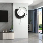 Modern luxury wall clock in a stylish living room with sleek decor and large windows.