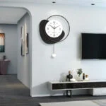 Modern luxury wall clock in a stylish living room with decorative accessories.