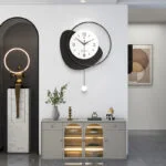 Modern luxury home decor with wall clock, sculpture, and decorative accessories.