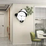 Modern panda-shaped wall clock in a stylish dining room setting.