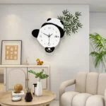 Modern panda-shaped wall clock in a stylish living room with plants and decor.