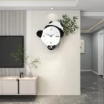 Modern panda-shaped wall clock in a stylish living room with minimalist decor.