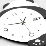 Modern panda-themed wall clock with black and white design, ideal for home decor.
