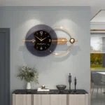 Modern luxury wall clock with gold accents in a stylish living room setting.