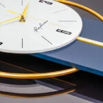 Modern luxury wall clock with gold accents and sleek design.