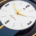 Modern luxury wall clock with gold accents and sleek design, perfect for home decor.