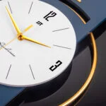 Modern luxury wall clock with gold accents and sleek design.
